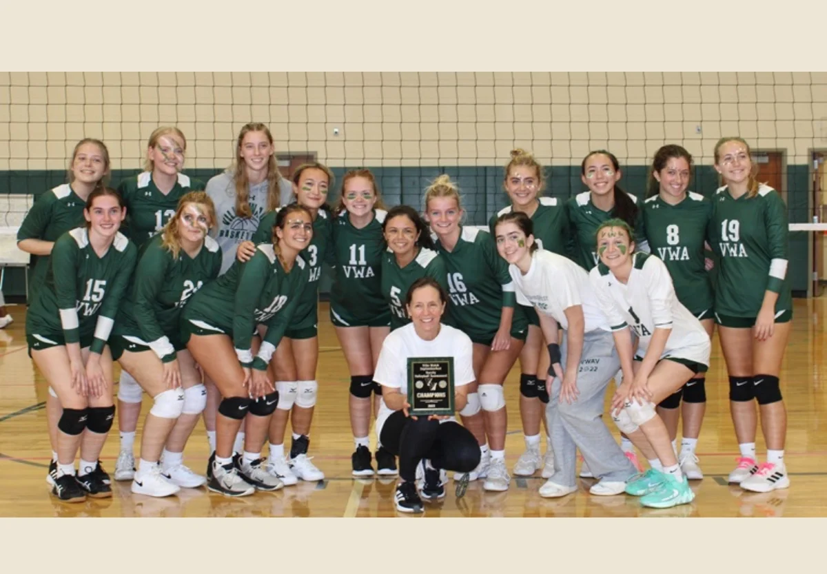 VWA varsity volleyball team holding award plaque